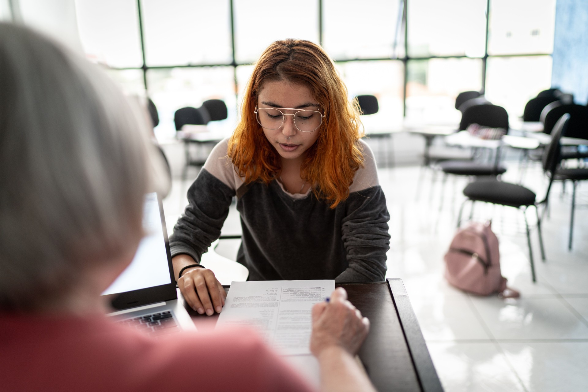 Teacher talking to student about test results at university or doing a job interview